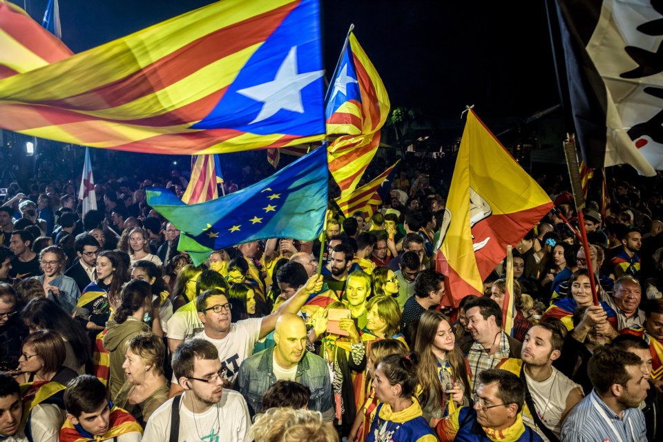 Simpatizantes de los independentistas de Junts pel Sí (Juntos por el Sí), ondean banderas durante la fiesta de noche del domingo.