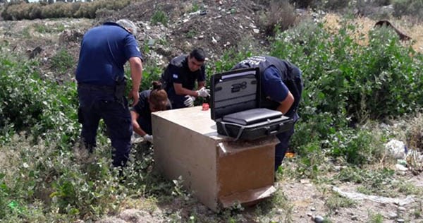 Personal policial de Criminalística trabajando en el lugar con la caja fuerte hallada en el barrio Amaya.