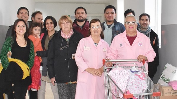 Organizadores de la campaña junto a las damas y elementos donados.